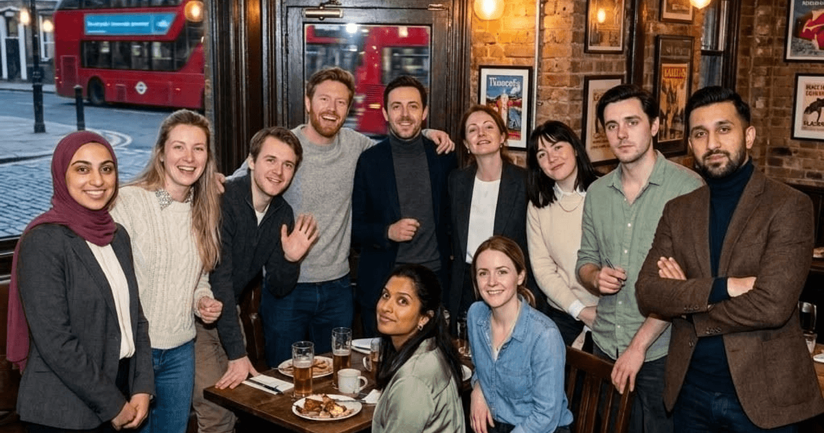 Digital Heroes London team at a Shoreditch pub with a red double-decker bus through the window